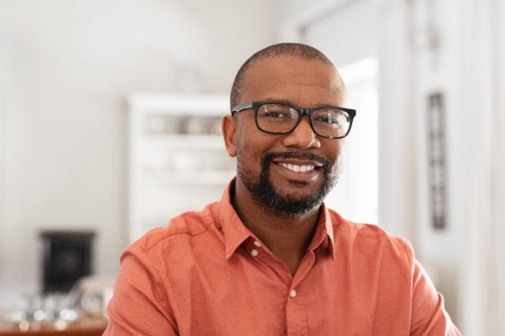 man with glasses smiling l dentist northcote