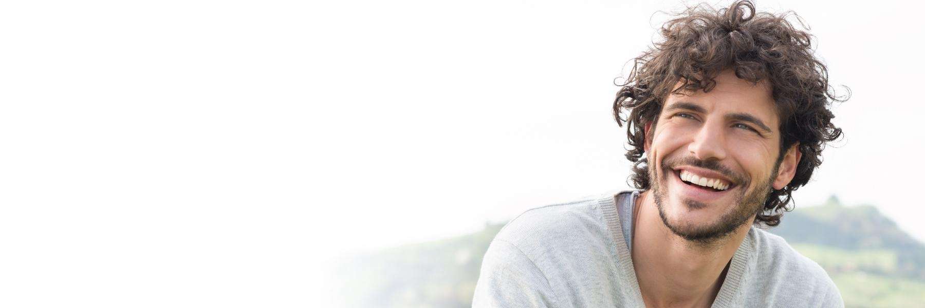 A smiling man in the mountains